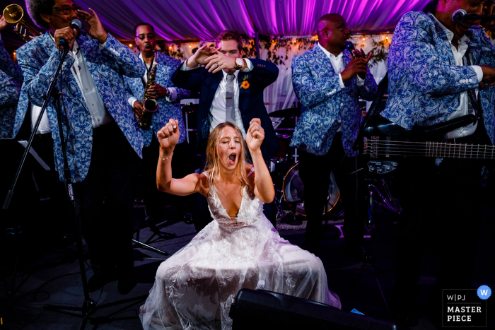 A Camp Hale documentary wedding photographer in Colorado captured this picture from the Dance Floor	as the Bride gets down