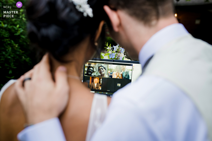 Ein erstklassiger dokumentarischer Hochzeitsfotograf aus Missouri hat dieses Bild von einer Outdoor-Hochzeitszeremonie der Braut und des Bräutigams auf Zoom erstellt