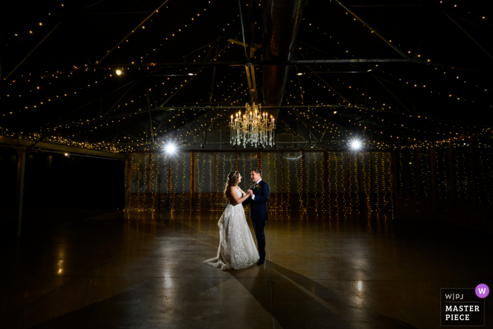 A top documentary wedding photographer at Berthoud, Colorado created this image of A bride and groom sharing their first dance A top documentary wedding photographer at Berthoud, Colorado created this image of A bride and groom sharing their first dance