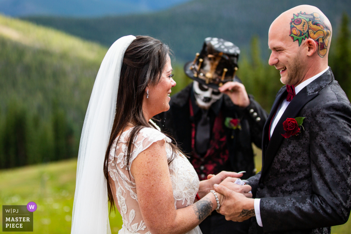 A Colorado wedding photojournalist at the Timber Ridge Lodge in Keystone captured this moment of Tears falling from the brides face as she giggles during the ceremony