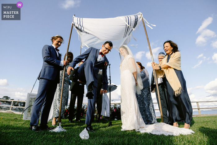 View this fine example of the best in the world wedding photography from the Provincetown Inn showing a Jewish wedding ceremony and the breaking of the glass