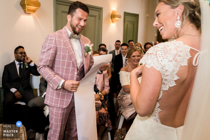 A Rotterdam documentary wedding photographer captured this moment at Dudok in Het Park showing that the groom has a very long story, vows for the bride during the ceremony