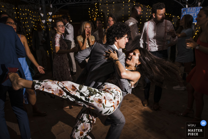 A Italy documentary-style wedding image showing a moment at Tenuta di Casa Bruciata showing some Bad dance moves