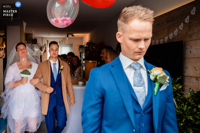 A top Netherlands wedding photojournalist from North Brabant created this image of a funny first look joke