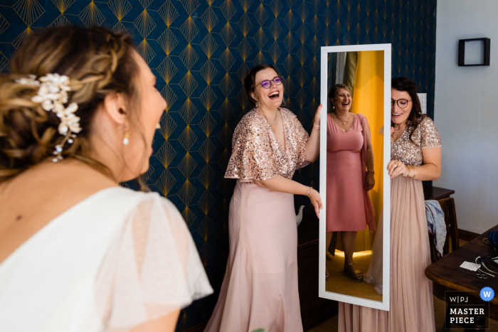 A France documentary wedding photographer at Domaine de Montauban captured this picture of the Bride discovering herself in the mirror