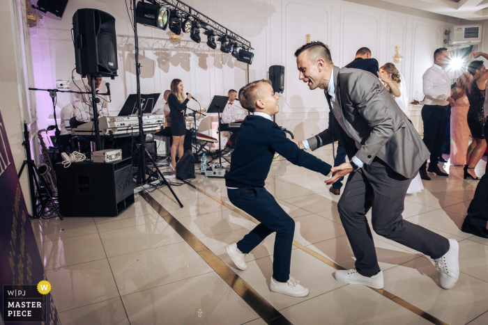 A Poland top wedding photojournalist at the Bej Hotel Tuszyn created this image of Dancing wedding guests