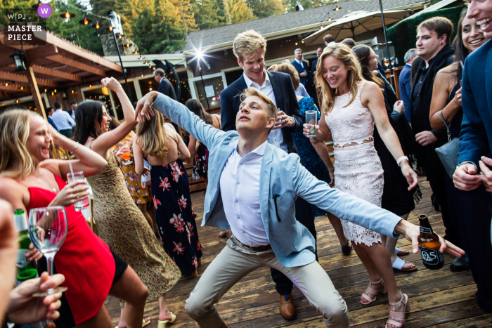 A California documentary wedding photographer at The Mountain Terrace captured this picture of a guest Dancing away with the exhilarated crowd in Woodside