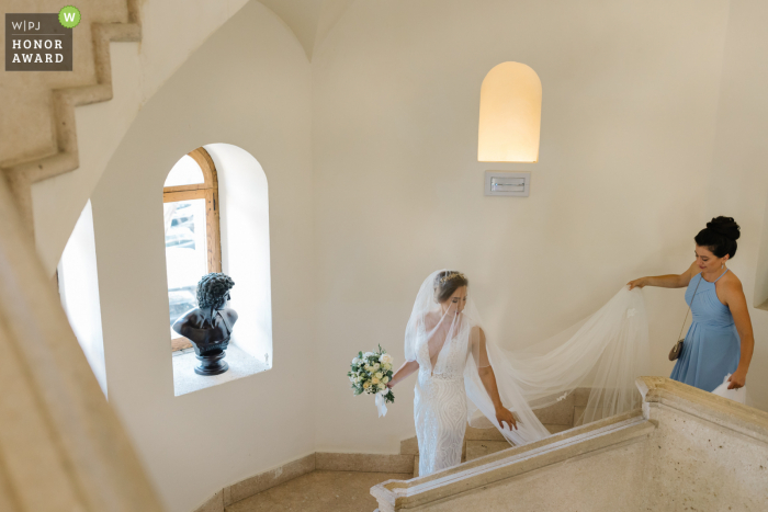 Zdjęcie ślubne z Grand Hotel dei Castelli w Ligurii przedstawiające Pannę Młodą pod dużym kątem przed ceremonią w hotelu schodzącą po schodach