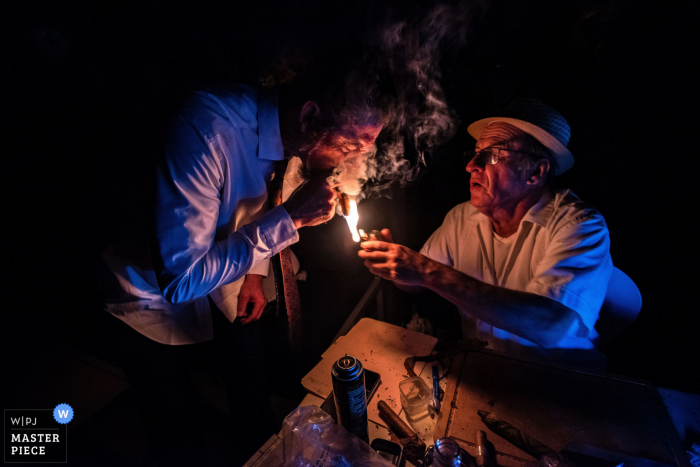 Best Scottsdale wedding venue photography at the Hotel Valley Ho in Arizona showing Groom gets a light for his cigar