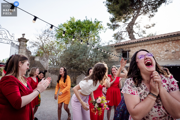 Best wedding photography from a Montagnac venue, Domaine de la Grangette capturing the Bouquet toss outdoors