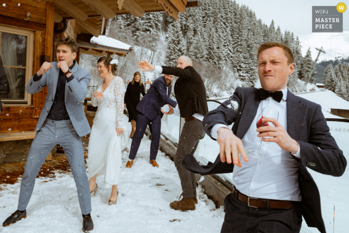 Best Gerlos Ski Resort wedding venue photography showing some winter Reception fun with a snowball fight outside