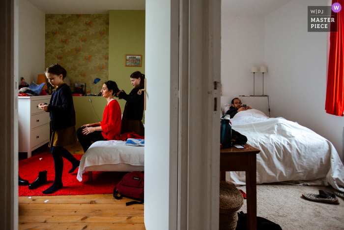 Paris based wedding and event photography of the Girls getting ready while the groomsmen is still in bed