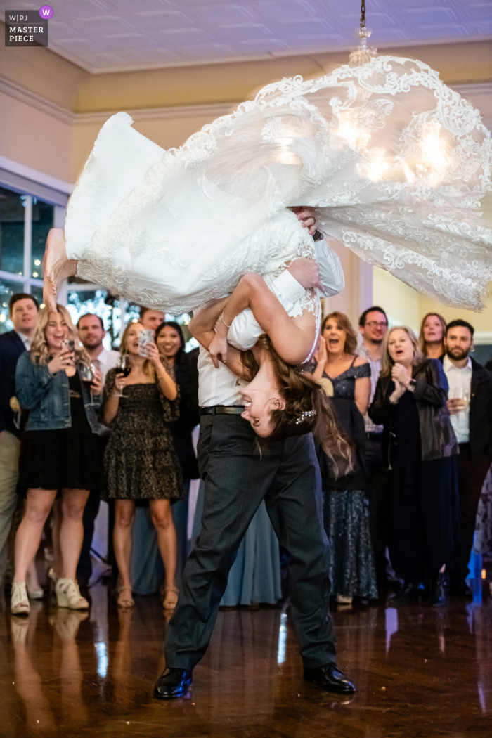 Best Santa Cruz wedding venue photography in California of Father and daughter do a surprise flip, Full frame, not cropped a hair