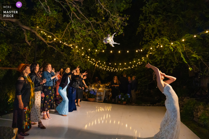 Altadena wedding photography of The bride throwing her bouquet to a group of single women