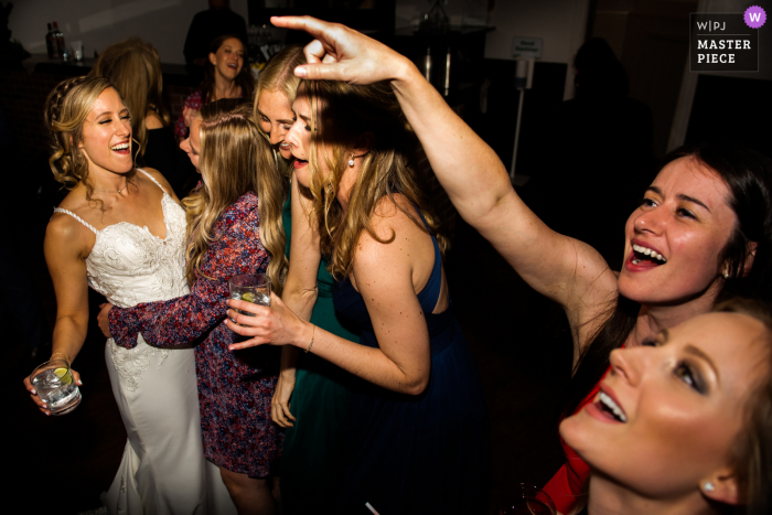 Toronto based wedding and event photography showing Bride is laughing on the dancing floor Toronto based wedding and event photography showing Bride is laughing on the dancing floor
