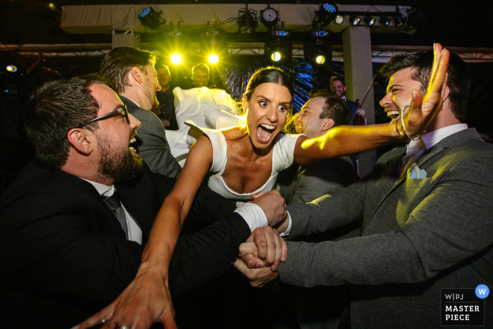 Imagen de una boda en Rio Grande do Sul de un lugar brasileño, Osteria Val de Buia, que muestra a la novia jugando en la fiesta Imagen de una boda en Rio Grande do Sul de un lugar brasileño, Osteria Val de Buia, que muestra a la novia jugando en la fiesta