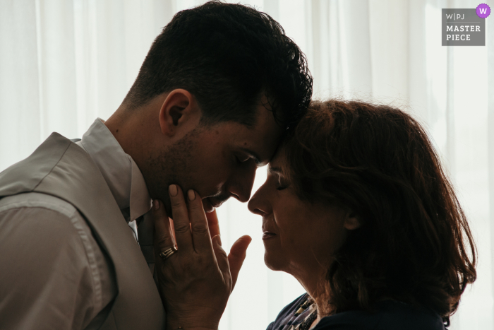 Erstklassiges dokumentarisches Hochzeitsbild aus Forli, Italien, von einem intimen Moment zwischen dem Bräutigam und seiner Mutter