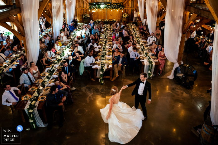 A Ticonderoga wedding photographer captured the couple's first dance at The Barn from above the dancefloor Documentary style photography from a New York wedding at The Barn at Lord Howe Valley of Ticonderoga created as The couple dances to their first dance
