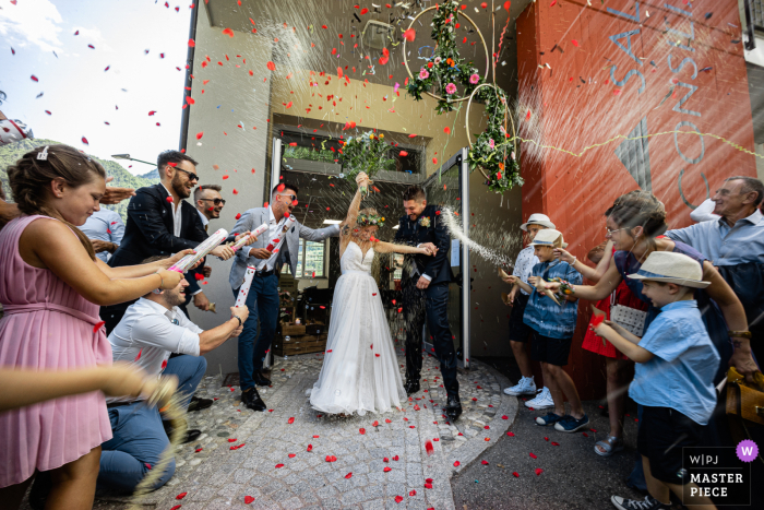 A Brescia wedding photographer at the Bagolino Municipal Hall created this image of the Throwing of rice after the ceremony A wedding photographer at the Municipal Hall created this image of the rice toss post ceremony