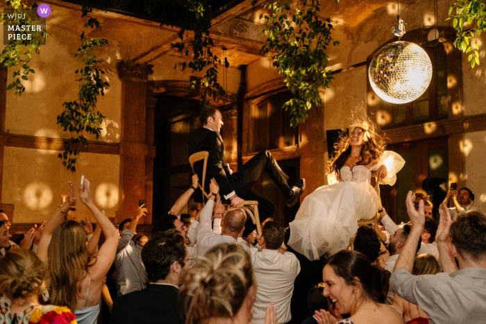 World class documentary wedding photography in Mexico City at Proyecto Prim during the bride and groom wedding reception hora chair dance 