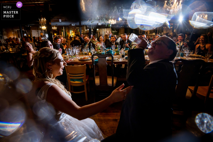 couple having drinks at reception Chicago contest award winning documentary wedding photography at Salvage One of the IL couple having drinks