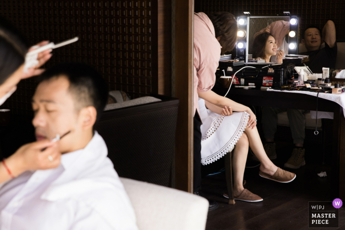 Mientras el fotógrafo de Zhejiang captura momentos sinceros, la novia y el novio se preparan juntos en partes separadas de las habitaciones del Hotel China, anticipando con entusiasmo su unión.