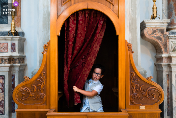 A young child played during the church wedding ceremony Matera Italy church image of a child during the celebration