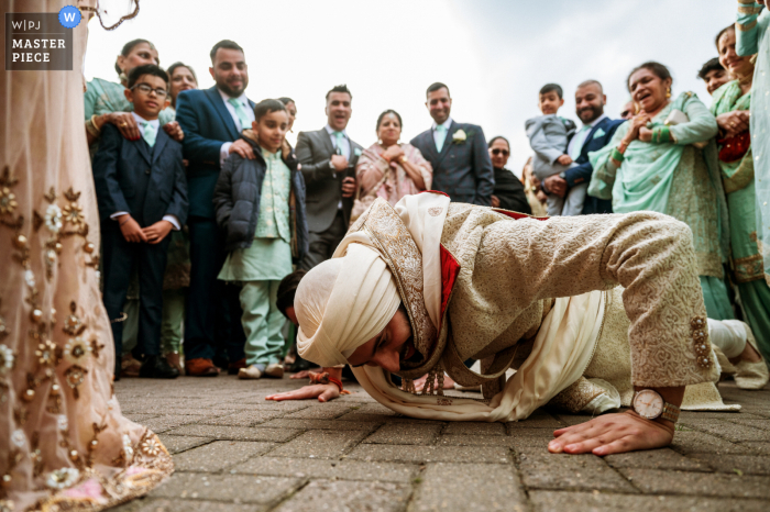 At Coventry, UK, a wedding picture captured a moment of the groom doing pushups on the stone paver walkway after an Asian ceremony and games
