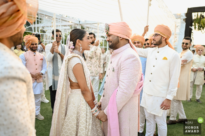 At the Jio convention in Mumbai, the groom is moved to tears as he lays eyes on his bride for the first time. This touching moment captures the love they share and their hopes for the future.