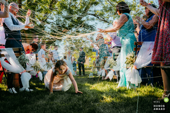 Guests Joyfully Engage in "Lancer de Laine" Ritual, Strengthening Couple's Bonds at Domaine de la Clausade, France Wedding At Domaine de la Clausade in Mauguio, France, guests participate in the "lancer de laine" (wool throwing) ritual, symbolizing the bonds between the couple and their loved ones.