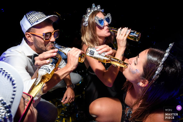 Party Hats, Beers, and Joy in Ibarlucea Village: A Fun Wedding Celebration Amidst the joyful celebrations, the guests in Argentina's Ibarlucea village dance and bond over cold beers and festive party hats.