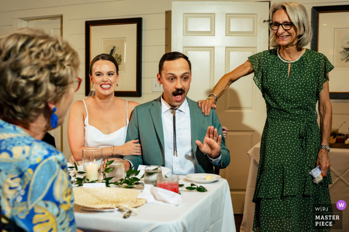 Amidst sentimental toasts, a groom lovingly silences his mother's embarrassing story at the beautiful Greystone Inn in Lake Toxaway, NC.