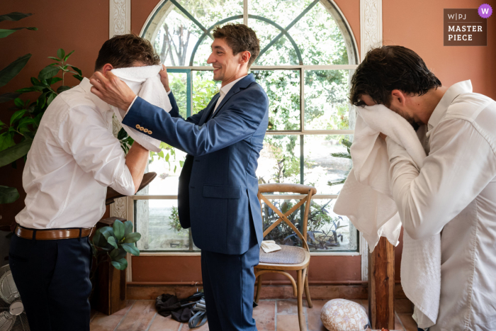 Groomsmen Chill in Historic French City | Hot Day, Cool Break, No Sweat! In the heat of the day, two groomsmen take a break from getting ready to cool off and wipe away the sweat in historic Nimes, France.
