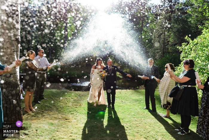 Newlywed's Beautiful Backdrop: South Lake Tahoe | Walking Through a Confetti Shower with Glowing Vibes After saying their vows, the newlyweds glow as they make their way through a shower of confetti in the beautiful backdrop of South Lake Tahoe.