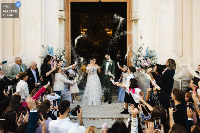 Newlyweds Blessed with Good Fortune by Loved Ones at Old World Church | Laigueglia Walking out of the quaint Old World church, the newlyweds are showered with good luck and joy by their loved ones in Laigueglia.