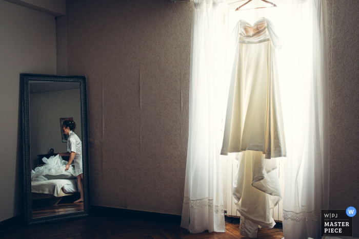 Pau Bride: Excited for the Final Touch in Her Quiet Prep Room In Pau, the bride calmly prepares for her special day, eagerly anticipating the final touch of her wedding attire.