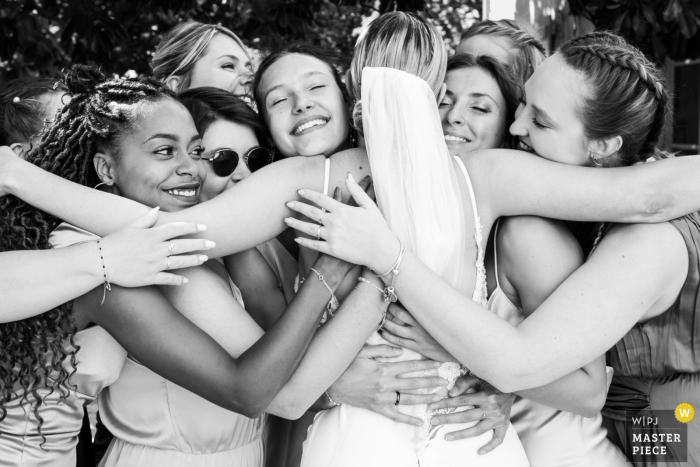 Bridesmaids Embrace Bride at Vienne Reception After First Look At the reception venue in Vienne, the bridesmaids share a loving embrace with the bride following the first look.