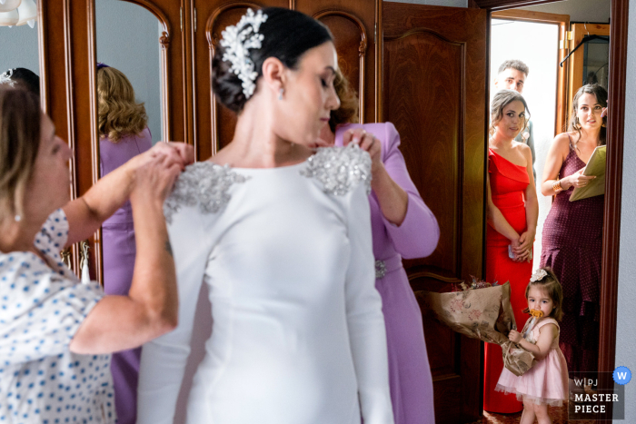 Amidst the bustle of the bride's house in Martos Jaén, Spain, many await with anticipation as the bride gets ready for her special day.