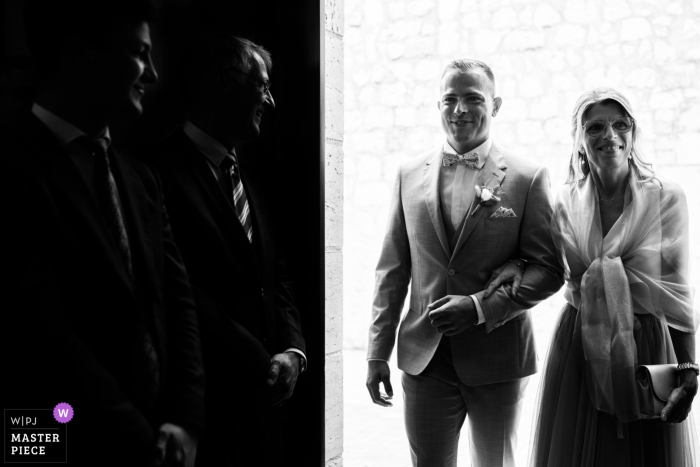 Happy Mom guides happy son to happily ever after in Pont du Casse, France The groom's mother lovingly escorts her son down the aisle towards his future at the picturesque Pont du Casse in Lot-et-Garonne.