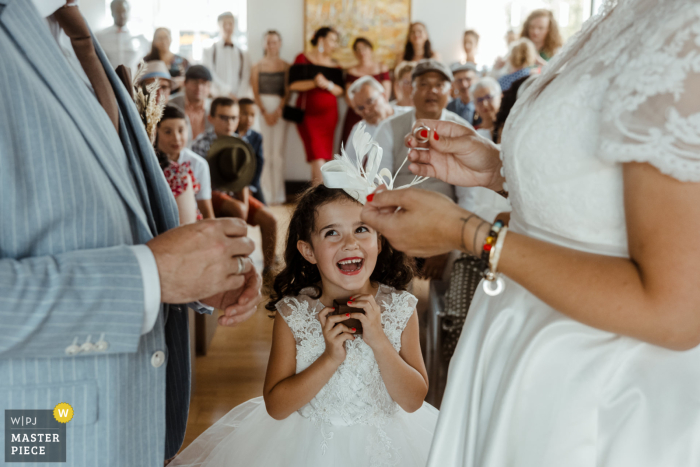 Proud Daughter Delivers Rings for Parents' Love: A Wedding in Trélazé, France Witnessing her parents' love, the bride's daughter proudly delivers the wedding rings at the ceremony in Trélazé, France.