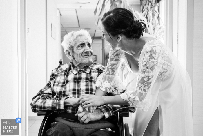 Grandfather's Loving Gaze from the Retirement Home in Auvergne-Rhône-Alpes on Bride's Special Day In this touching moment from their wedding day, the bride's, now deceased, grandfather watches over her with love from his retirement home in Auvergne-Rhône-Alpes.