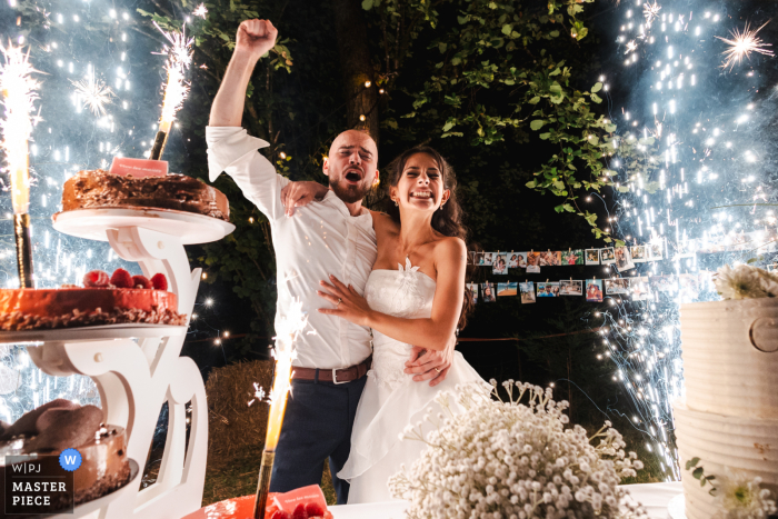 Newlyweds Celebrate Special Day in Montreux-Vieux, Alsace: Fireworks and Cake Galore Amidst the glow of fireworks and the delicious wedding cake, the newlyweds celebrate their special day in the town of Montreux-Vieux, Alsace.