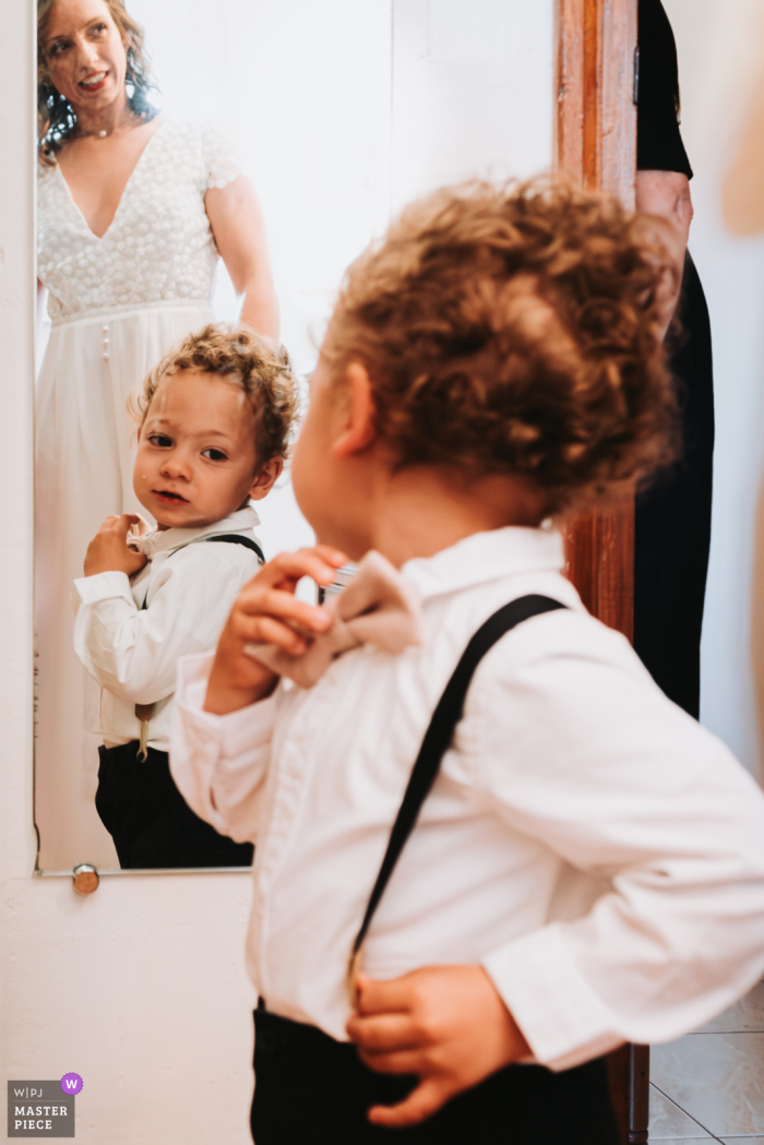 Growing Up: A Son's Special Role in His Parents' Day in Pierrefeu-du-Var, France Little man all grown up, ready to be a part of his parents' special day at their home in Pierrefeu-du-Var, France captured by a WPJA wedding photographer.