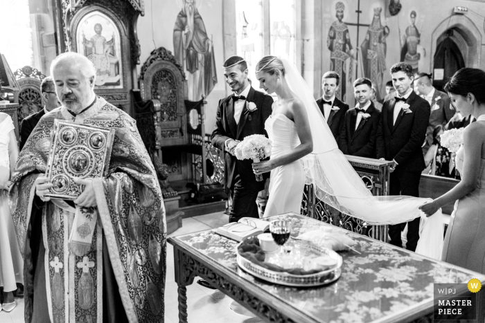Happy Moment Captured: Greek Church Wedding in Buckinghamshire, UK Transported back in time in a BW image, the bride and groom share a moment of pure joy and love during their Greek wedding ceremony captured in beautiful Buckinghamshire, UK.