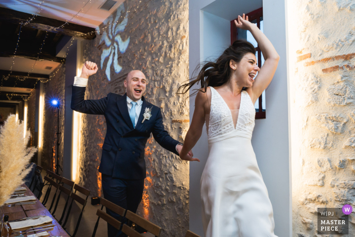 Joyful Newlyweds at Château Saint Denis Reception Party, Hand in Hand The bride and groom can't contain their joy as they happily run hand in hand through Château Saint Denis, at the reception party.