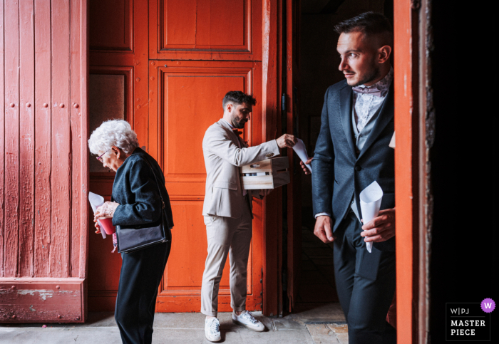 Adding Love & Beauty: Witness Scatters Petals at Châteauroux Wedding A witness distributes petals at the wedding, adding a touch of love and beauty to the ceremony captured by a WPJA photographer in Châteauroux.
