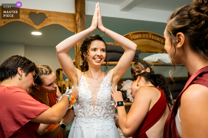 Surrounded by love, the bride eagerly awaits her special day with the help of her devoted bridesmaids at Gîte L'essentiel.