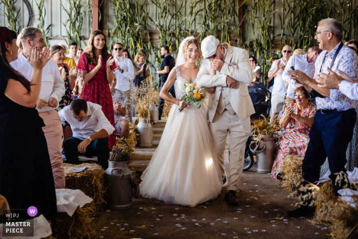 Love and happiness filled the air as the bride's father gave her a tender kiss on their family farm in Haute Marne while bringing air through the aisle.
