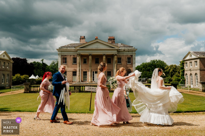 The Wedding Party Headed to Hale Park House for the Ceremony The wedding party bravely made their way to the church through the grounds of Hale Park House, ready to face whatever the weather may bring.