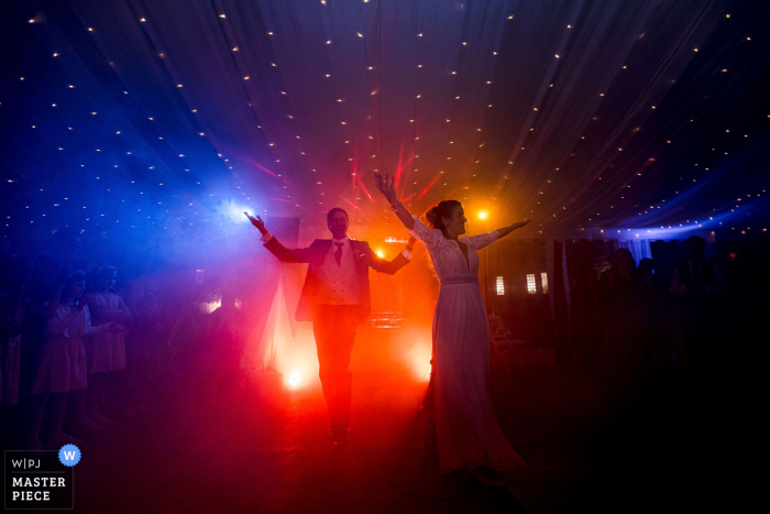 Couple Dances Enthusiastically Under Vibrant DJ Lights at Château de Thorens, France At Château de Thorens, France, the dancefloor comes alive as the couple enthusiastically dances under vibrant DJ lights, setting the scene for an unforgettable night.